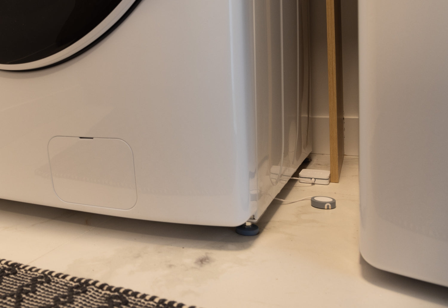 Water leak detector with sensor near the washing machine